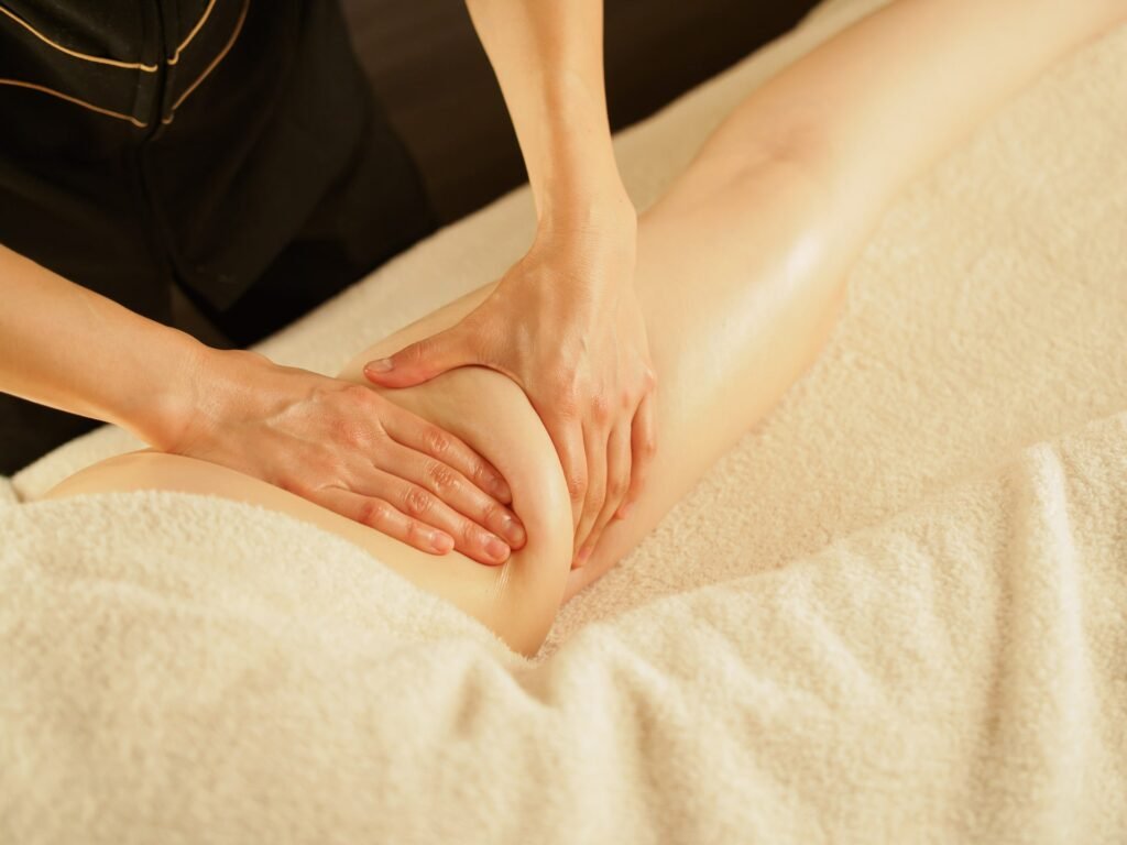 A TCM practitioner gently massages the leg to improve circulation and reduce cellulite, promoting smoother and firmer skin.