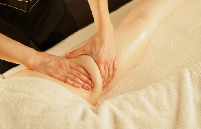 A TCM practitioner gently massages the leg to improve circulation and reduce cellulite, promoting smoother and firmer skin.