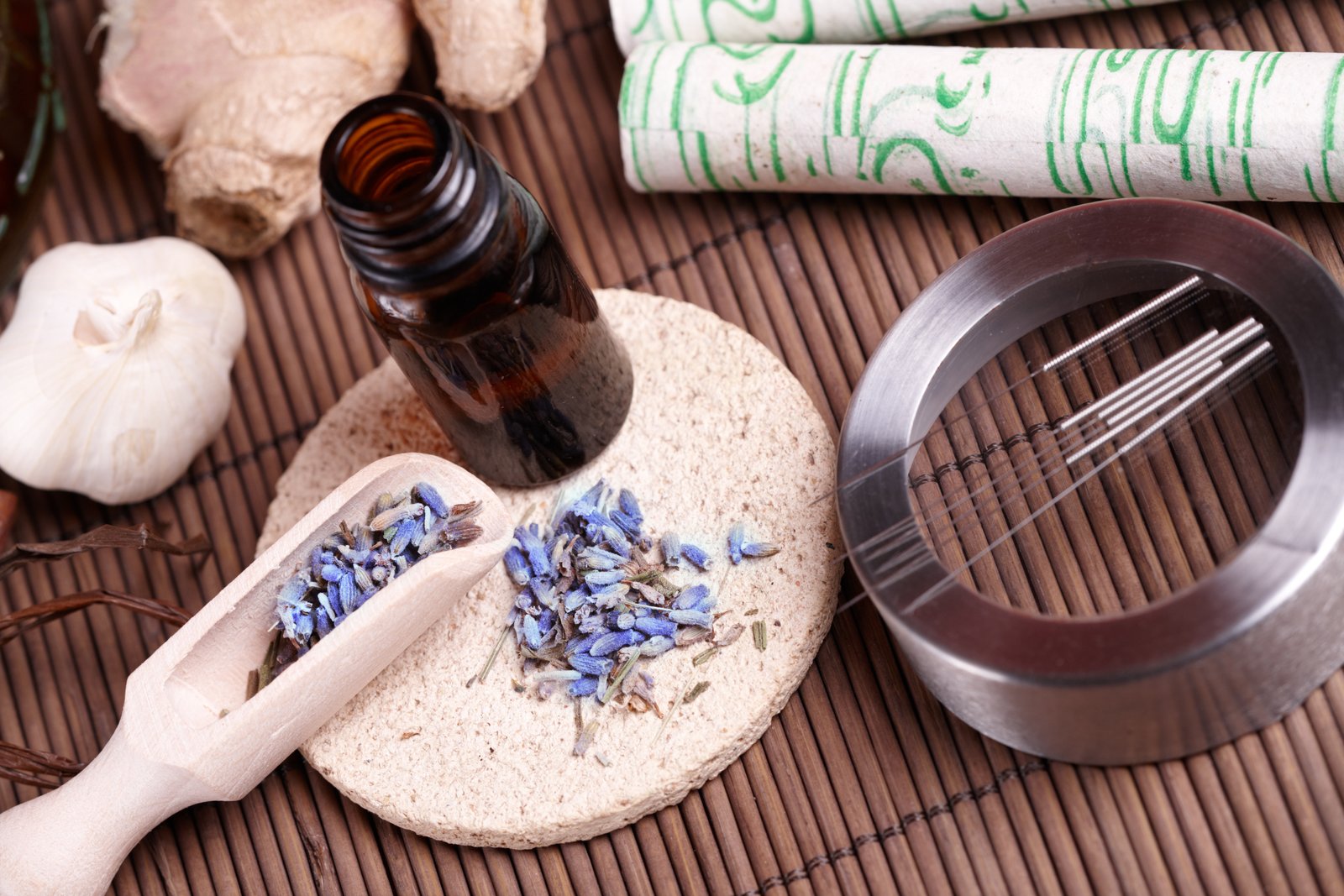 Acupuncture needles and TCM herbs arranged on a table, representing natural hormone-balancing therapies